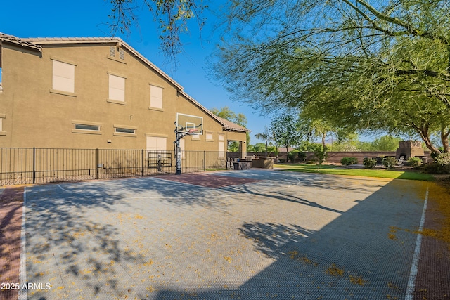 2735 E Flower Ct, Gilbert, AZ 85298 - view of side of home featuring stucco siding, basketball hoop, and fence