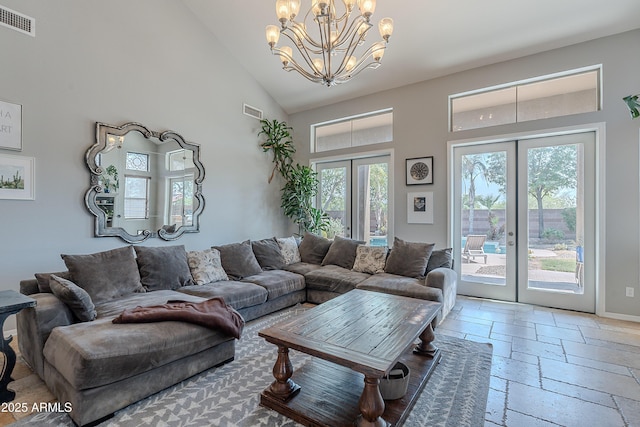 2735 E Flower Ct, Gilbert, AZ 85298 - living area with french doors, stone tile floors, a chandelier, and high vaulted ceiling