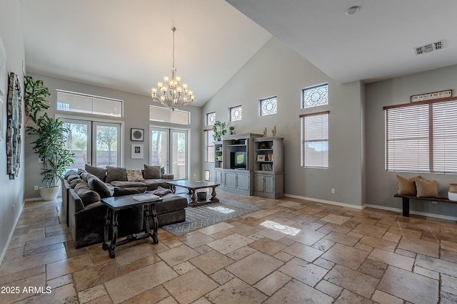 2735 E Flower Ct, Gilbert, AZ 85298 - living area featuring stone tile flooring, high vaulted ceiling, a chandelier, healthy amount of natural light, and baseboards