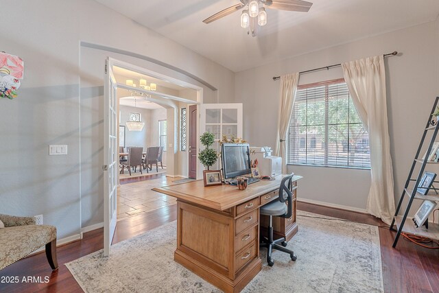 2735 E Flower Ct, Gilbert, AZ 85298 - home office featuring arched walkways, wood finished floors, baseboards, and ceiling fan