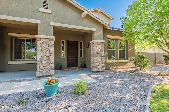 2735 E Flower Ct, Gilbert, AZ 85298 - entrance to property featuring stucco siding, stone siding, fence, and a tile roof
