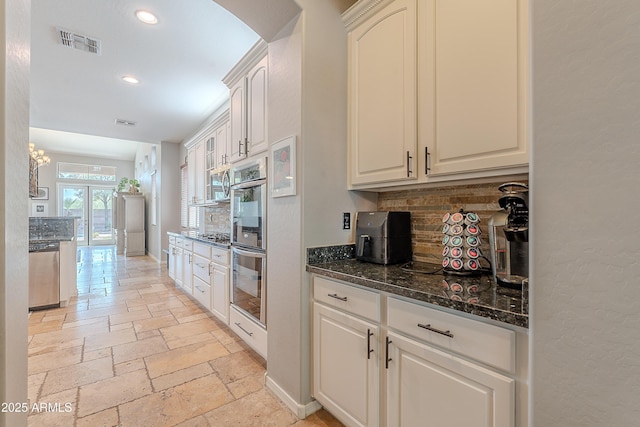 2735 E Flower Ct, Gilbert, AZ 85298 - kitchen with stone tile floors, backsplash, stainless steel appliances, recessed lighting, and dark stone counters
