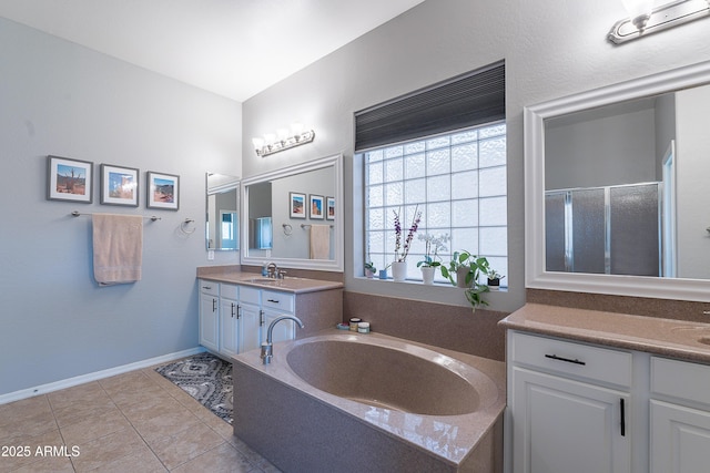 2735 E Flower Ct, Gilbert, AZ 85298 - full bathroom with two vanities, a shower stall, a garden tub, tile patterned floors, and baseboards