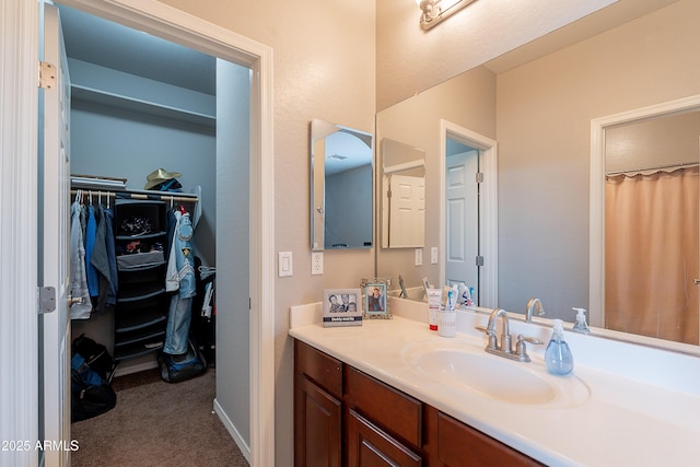 2735 E Flower Ct, Gilbert, AZ 85298 - bathroom featuring vanity, a spacious closet, and baseboards