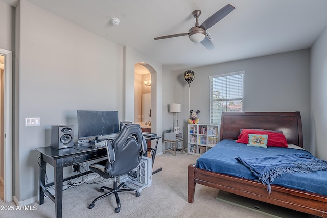 2735 E Flower Ct, Gilbert, AZ 85298 - carpeted bedroom with arched walkways, a desk, ensuite bath, baseboards, and a ceiling fan