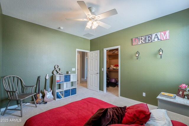 2735 E Flower Ct, Gilbert, AZ 85298 - carpeted bedroom featuring a walk in closet, baseboards, and ceiling fan