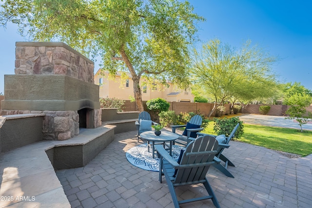 2735 E Flower Ct, Gilbert, AZ 85298 - view of patio / terrace with an outdoor stone fireplace and fence