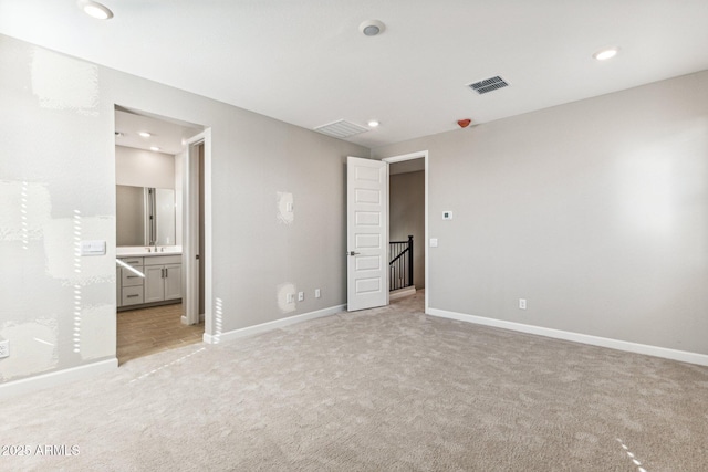 unfurnished bedroom with recessed lighting, baseboards, visible vents, and light carpet