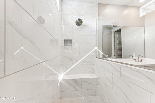 bathroom featuring vanity and tiled shower