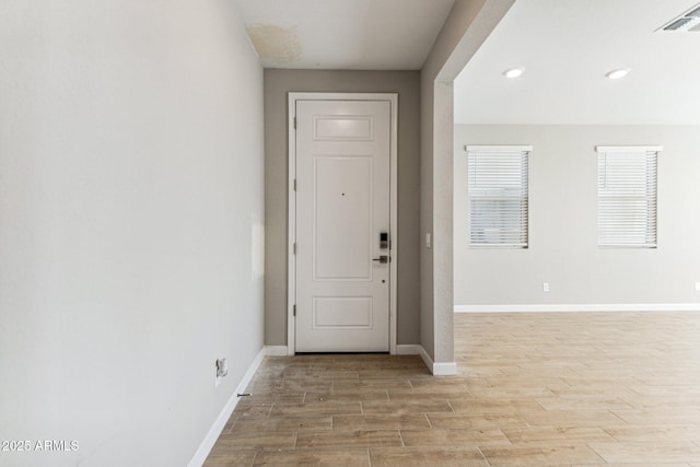 entrance foyer featuring visible vents, baseboards, and light wood-style flooring