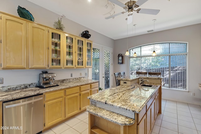 kitchen featuring stainless steel dishwasher, sink, light tile patterned floors, and an island with sink