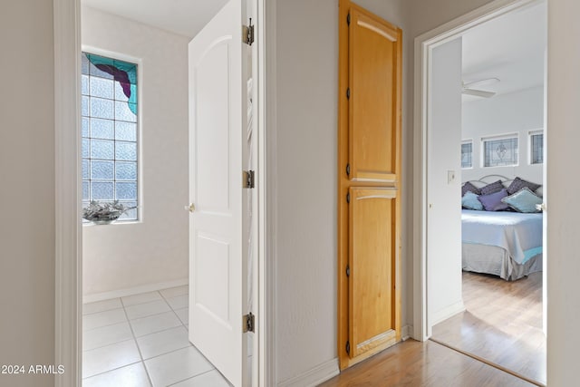 hallway with light hardwood / wood-style floors