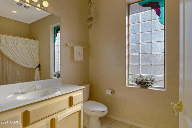 bathroom featuring tile patterned floors, plenty of natural light, and toilet