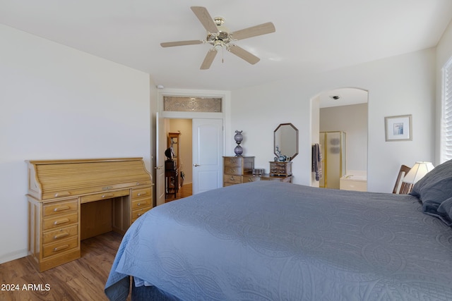 bedroom featuring ceiling fan, light wood-type flooring, and ensuite bath