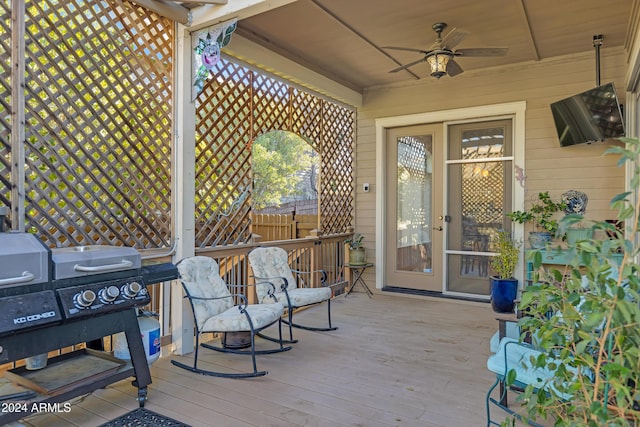 wooden terrace featuring area for grilling and ceiling fan