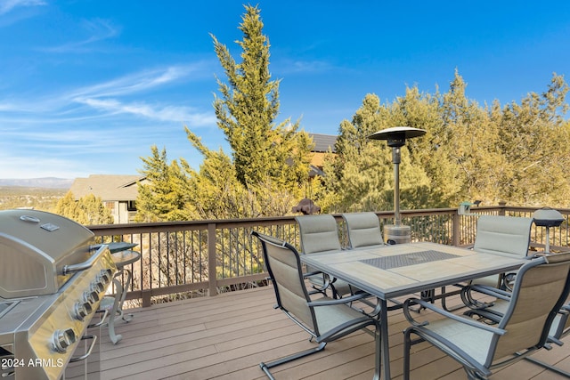 deck with area for grilling and a mountain view