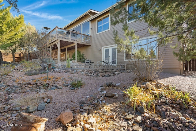 back of house with french doors and a deck