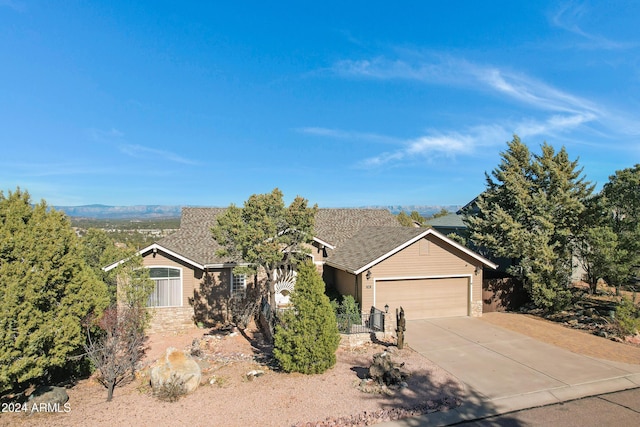 view of front of property with a mountain view and a garage