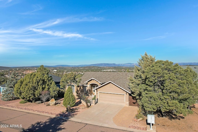 view of front of home with a mountain view and a garage