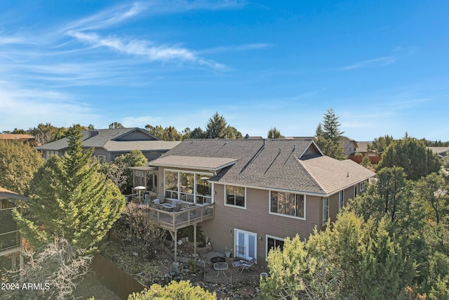 rear view of property with a wooden deck and french doors