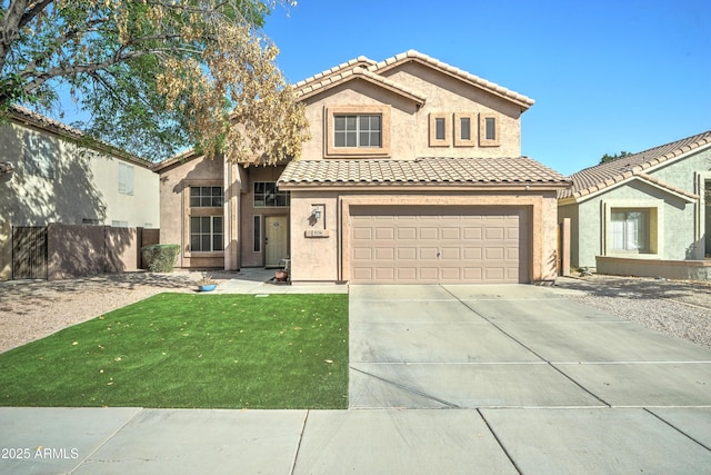 view of front of property with concrete driveway, fence, a tiled roof, and stucco siding