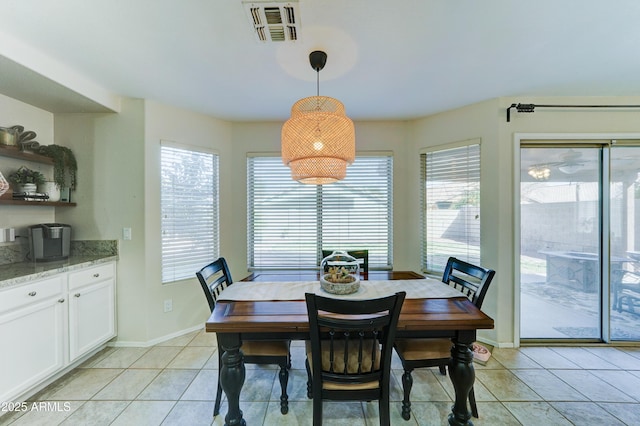 dining area featuring light tile patterned floors, visible vents, and baseboards