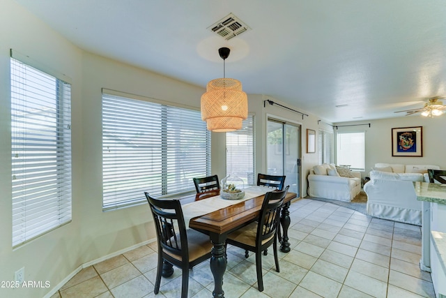 dining space featuring visible vents, ceiling fan, baseboards, and light tile patterned floors