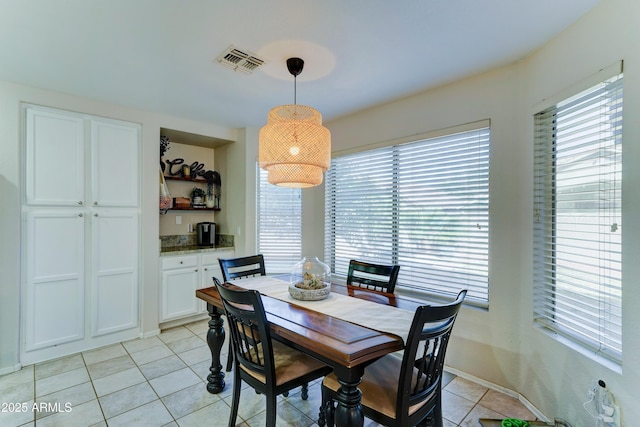 dining room featuring visible vents and light tile patterned flooring