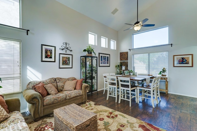 living room with high vaulted ceiling, wood finished floors, and visible vents