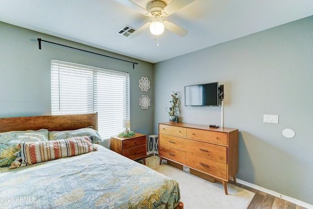 bedroom with baseboards, visible vents, and ceiling fan