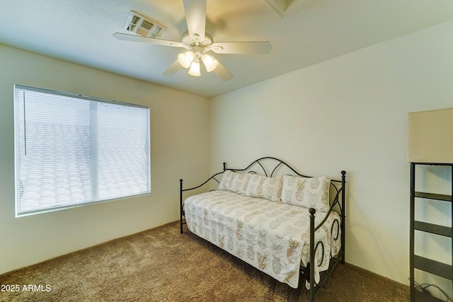 carpeted bedroom with ceiling fan and visible vents