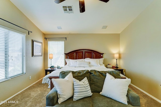 carpeted bedroom featuring ceiling fan, lofted ceiling, visible vents, and baseboards