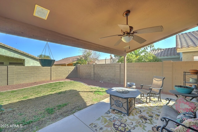 view of patio / terrace featuring ceiling fan, an outdoor fire pit, and a fenced backyard