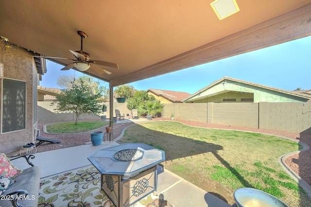 view of patio / terrace with a fire pit, ceiling fan, and a fenced backyard