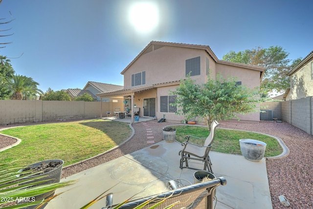 rear view of house featuring a patio, a fenced backyard, a yard, central air condition unit, and stucco siding