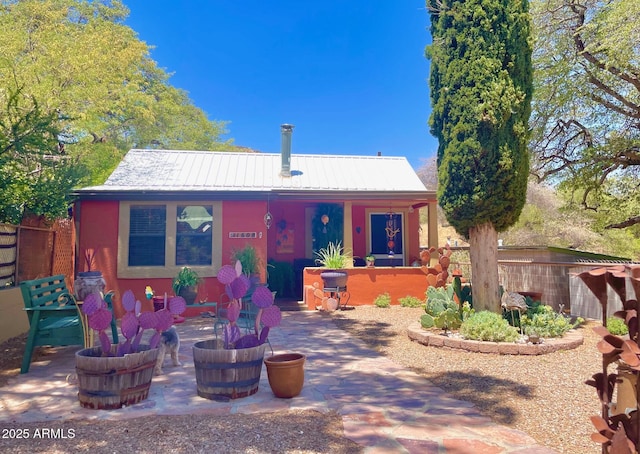 1608 W W Blvd, Bisbee, AZ 85603 - view of front of home with metal roof, a patio, and stucco siding