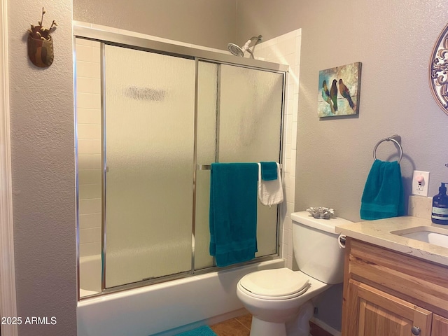 1608 W W Blvd, Bisbee, AZ 85603 - full bathroom with a textured wall, toilet, vanity, combined bath / shower with glass door, and tile patterned floors