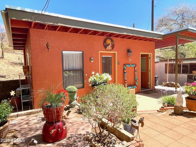 1608 W W Blvd, Bisbee, AZ 85603 - view of front of house featuring stucco siding and a patio area