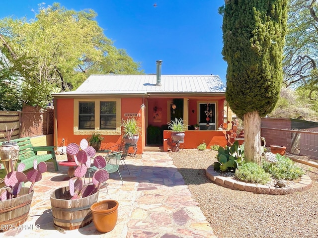 1608 W W Blvd, Bisbee, AZ 85603 - back of property with metal roof, a patio, and stucco siding
