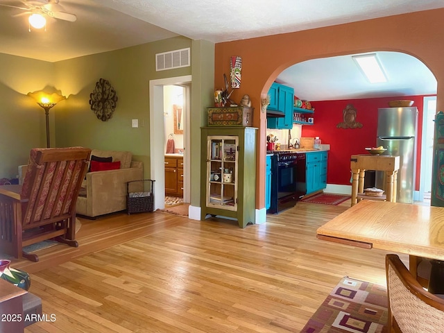 1608 W W Blvd, Bisbee, AZ 85603 - living area featuring arched walkways, light wood-style flooring, and ceiling fan