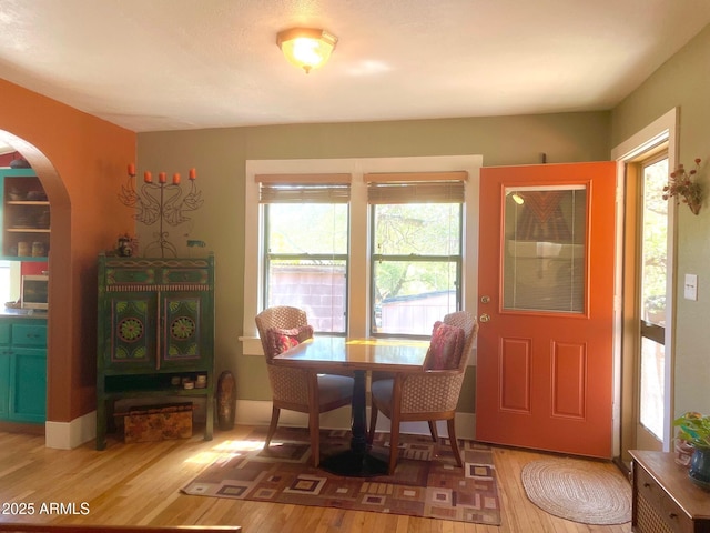 1608 W W Blvd, Bisbee, AZ 85603 - dining room featuring wood finished floors, plenty of natural light, and arched walkways