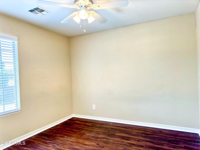 unfurnished room with ceiling fan, wood-type flooring, and a healthy amount of sunlight