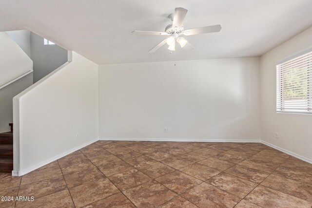 spare room featuring tile patterned floors, a textured ceiling, and ceiling fan