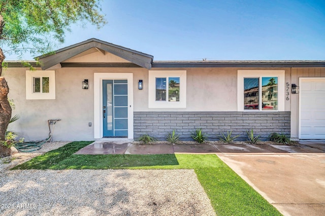 5236 S 19th Ave, Phoenix, AZ 85041 - view of front of house with stucco siding, brick siding, and a garage