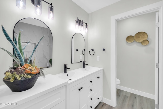 5236 S 19th Ave, Phoenix, AZ 85041 - bathroom with toilet, double vanity, wood finished floors, and baseboards