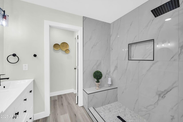 5236 S 19th Ave, Phoenix, AZ 85041 - full bath with a marble finish shower, wood finished floors, vanity, and baseboards