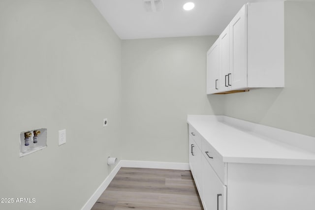 5236 S 19th Ave, Phoenix, AZ 85041 - washroom featuring washer hookup, light wood finished floors, hookup for an electric dryer, baseboards, and cabinet space