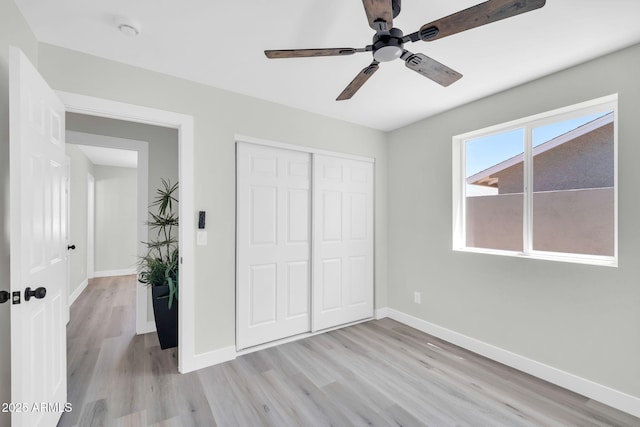 5236 S 19th Ave, Phoenix, AZ 85041 - unfurnished bedroom with light wood-style flooring, a closet, baseboards, and ceiling fan