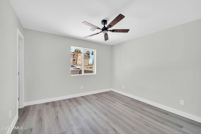 5236 S 19th Ave, Phoenix, AZ 85041 - spare room with wood finished floors, a ceiling fan, and baseboards