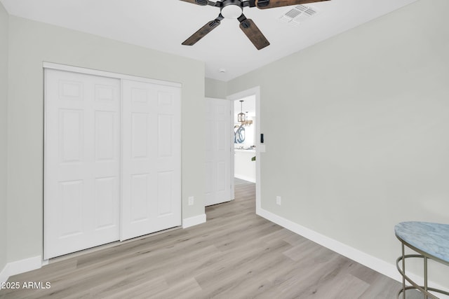5236 S 19th Ave, Phoenix, AZ 85041 - unfurnished bedroom with wood finished floors, baseboards, and a closet